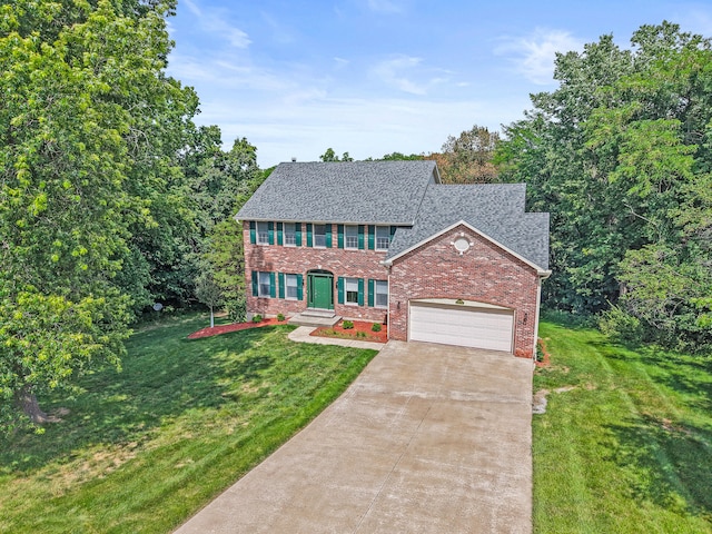 3348 S Old Ridge Rd, Columbia, MO 65203 - colonial inspired home with brick siding, a front lawn, concrete driveway, an attached garage, and roof with shingles
