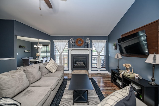 5808 Islip Dr, Columbia, MO 65201 - living area featuring vaulted ceiling, wood finished floors, a chandelier, ceiling fan, and a glass covered fireplace