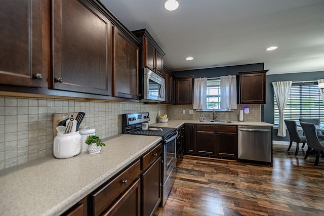 5808 Islip Dr, Columbia, MO 65201 - kitchen with stainless steel appliances, dark brown cabinetry, light countertops, dark wood finished floors, and recessed lighting
