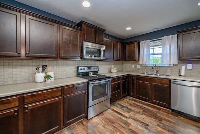5808 Islip Dr, Columbia, MO 65201 - kitchen featuring appliances with stainless steel finishes, dark wood finished floors, dark brown cabinets, light countertops, and recessed lighting