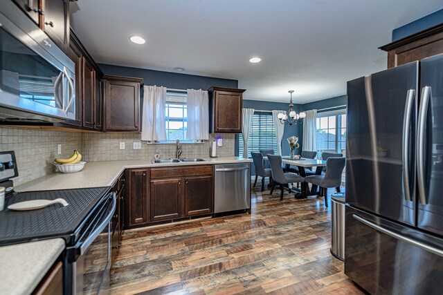 5808 Islip Dr, Columbia, MO 65201 - kitchen with stainless steel appliances, a chandelier, dark brown cabinetry, and recessed lighting