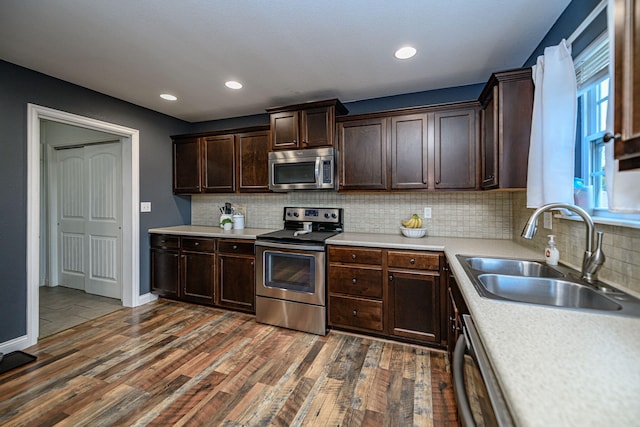 5808 Islip Dr, Columbia, MO 65201 - kitchen with stainless steel appliances, dark brown cabinets, tasteful backsplash, light countertops, and recessed lighting