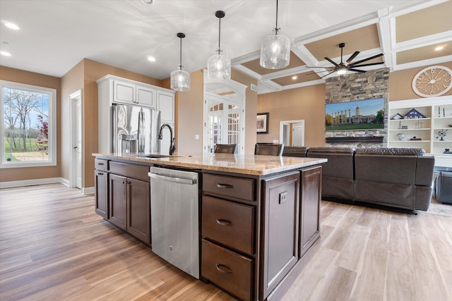 6406 Crooked Switch Ct, Columbia, MO 65201 - kitchen with stainless steel appliances, a ceiling fan, light wood finished floors, light stone counters, and coffered ceiling