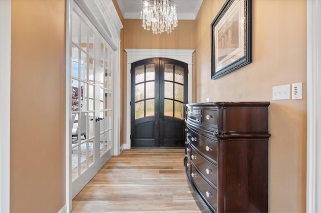 6406 Crooked Switch Ct, Columbia, MO 65201 - foyer with french doors, a chandelier, light wood-style floors, and crown molding