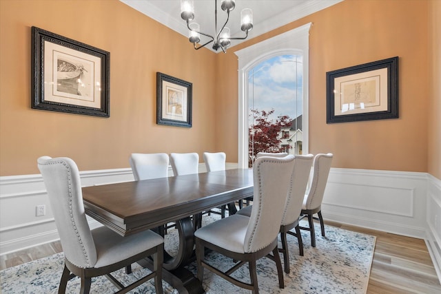 6406 Crooked Switch Ct, Columbia, MO 65201 - dining space with a chandelier, wainscoting, light wood-style flooring, a decorative wall, and crown molding