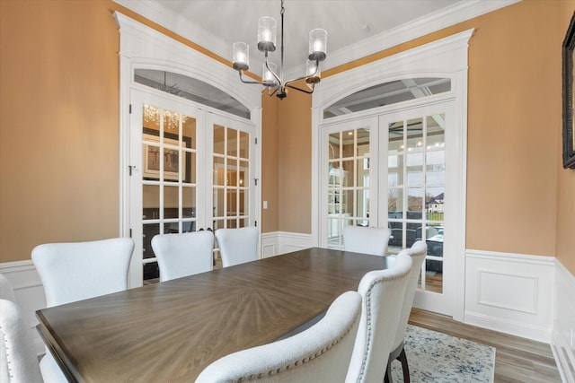 6406 Crooked Switch Ct, Columbia, MO 65201 - dining room featuring french doors, a chandelier, a wainscoted wall, wood finished floors, and crown molding