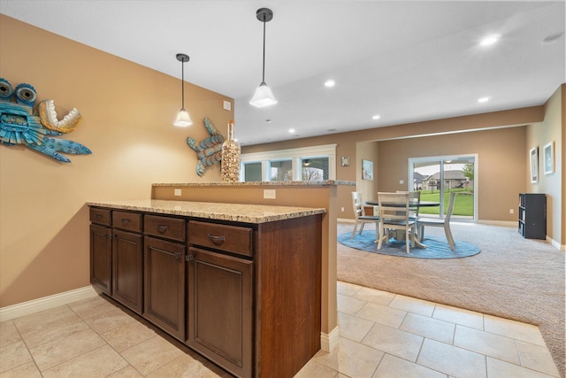 6406 Crooked Switch Ct, Columbia, MO 65201 - kitchen with light carpet, a peninsula, recessed lighting, pendant lighting, and dark brown cabinets