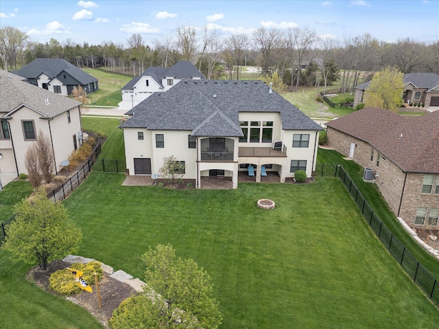 6406 Crooked Switch Ct, Columbia, MO 65201 - rear view of property featuring a shingled roof, stucco siding, a residential view, a fenced backyard, and a fire pit