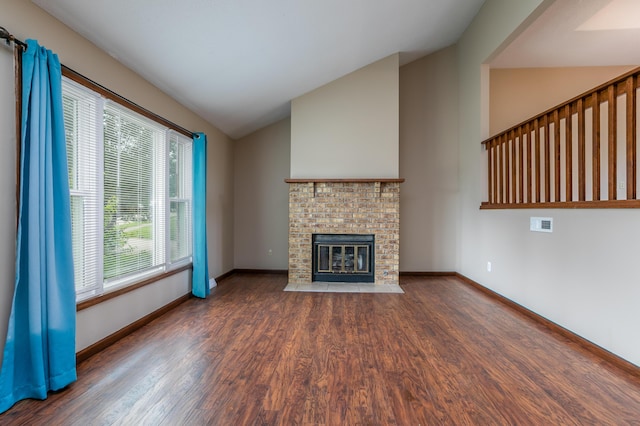 2109 Bridgewater Dr, Columbia, MO 65202 - unfurnished living room with wood finished floors, a brick fireplace, and high vaulted ceiling
