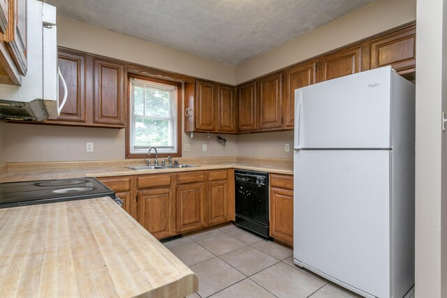 2109 Bridgewater Dr, Columbia, MO 65202 - kitchen featuring white appliances, brown cabinetry, and light tile patterned floors