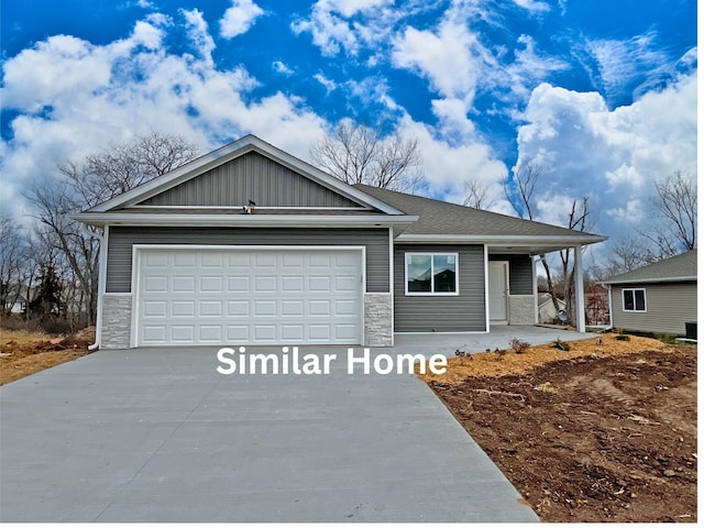7809 N Brookhill Dr, Columbia, MO 65202 - ranch-style home with driveway, stone siding, an attached garage, and covered porch
