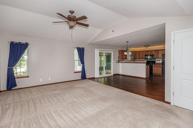 9855 N Route E, Harrisburg, MO 65256 - unfurnished living room featuring dark colored carpet, lofted ceiling, ceiling fan, plenty of natural light, and dark wood finished floors
