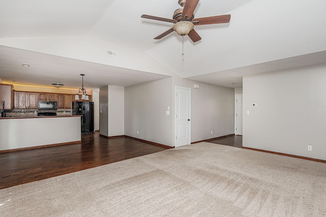 9855 N Route E, Harrisburg, MO 65256 - unfurnished living room with dark carpet, ceiling fan, and high vaulted ceiling