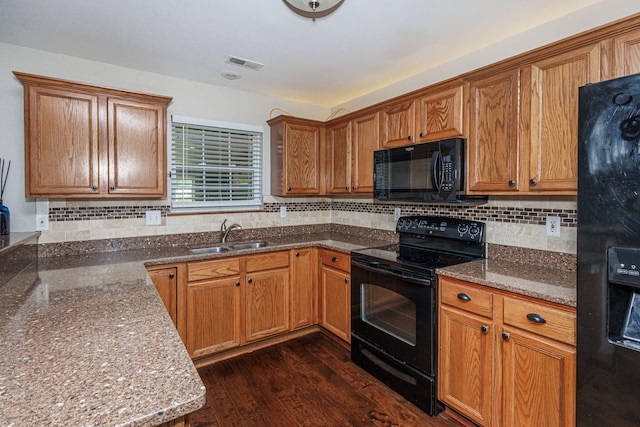9855 N Route E, Harrisburg, MO 65256 - kitchen featuring black appliances, tasteful backsplash, dark stone countertops, and brown cabinetry