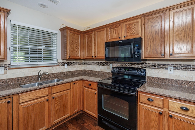 9855 N Route E, Harrisburg, MO 65256 - kitchen featuring black appliances, dark wood-type flooring, brown cabinetry, and tasteful backsplash