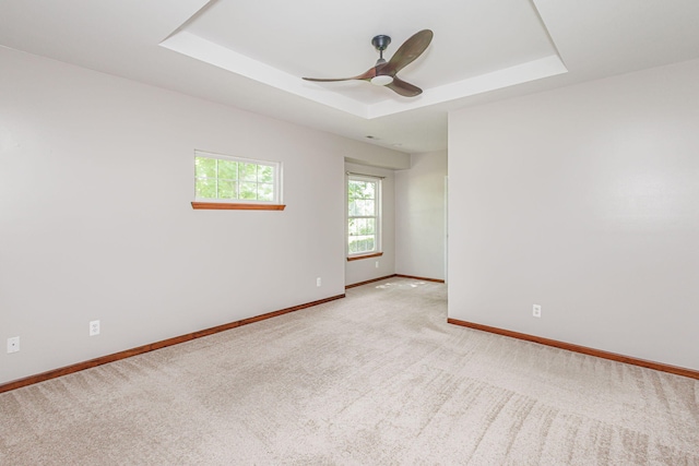 9855 N Route E, Harrisburg, MO 65256 - empty room with a tray ceiling, light colored carpet, and ceiling fan