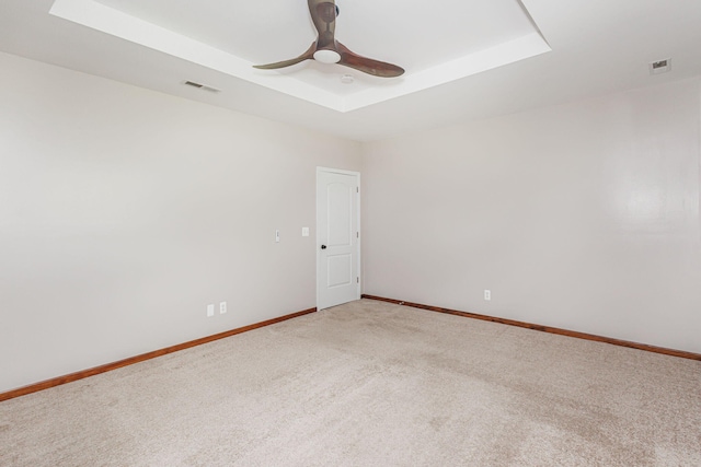 9855 N Route E, Harrisburg, MO 65256 - unfurnished room featuring a tray ceiling, carpet floors, and ceiling fan