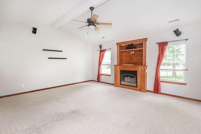 9855 N Route E, Harrisburg, MO 65256 - unfurnished living room featuring healthy amount of natural light, light carpet, a glass covered fireplace, and ceiling fan
