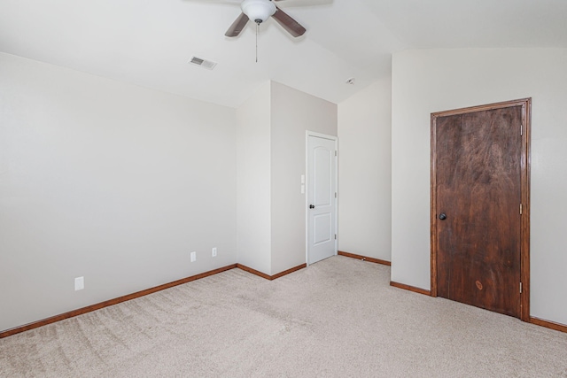 9855 N Route E, Harrisburg, MO 65256 - unfurnished bedroom featuring light colored carpet, vaulted ceiling, a closet, and a ceiling fan