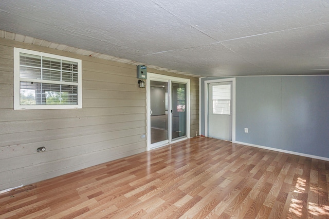 9855 N Route E, Harrisburg, MO 65256 - spare room with wood finished floors, wood walls, and plenty of natural light