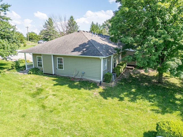 9855 N Route E, Harrisburg, MO 65256 - rear view of property with a shingled roof and a yard