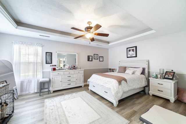 605 Teakwood Ct, Ashland, MO 65010 - bedroom featuring a tray ceiling, light wood finished floors, and ceiling fan