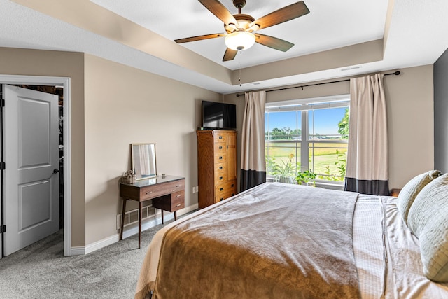 6655 American Setter Dr, Ashland, MO 65010 - carpeted bedroom featuring a raised ceiling and ceiling fan