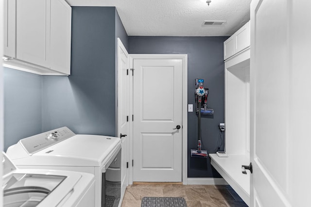 6655 American Setter Dr, Ashland, MO 65010 - washroom with independent washer and dryer, cabinet space, and a textured ceiling
