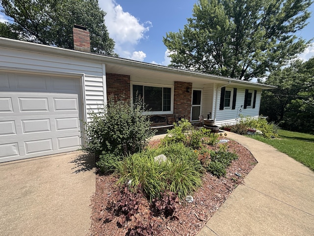 14200 N Yy, Columbia, MO 65202 - single story home with a chimney, a garage, and brick siding
