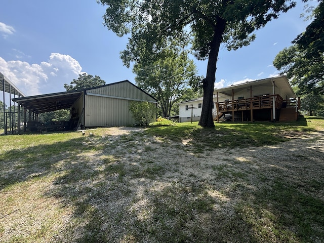 14200 N Yy, Columbia, MO 65202 - view of yard featuring a wooden deck, a carport, a pole building, an outdoor structure, and stairs