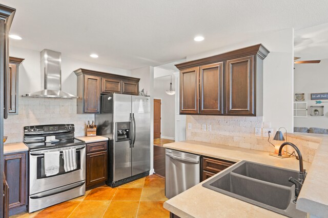 6003 Misty Springs Way, Columbia, MO 65202 - kitchen with stainless steel appliances, wall chimney range hood, light countertops, backsplash, and recessed lighting