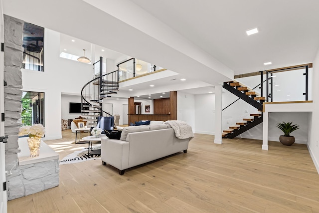 1805 Woodrail Ave, Columbia, MO 65203 - living area featuring stairway, light wood finished floors, a high ceiling, and recessed lighting