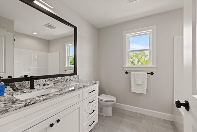 924 Engle Dr, Columbia, MO 65203 - bathroom with vanity, healthy amount of natural light, and a shower