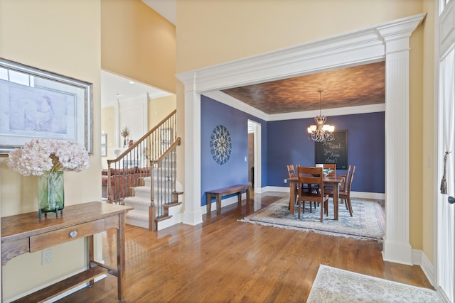4902 Cochero Ct, Columbia, MO 65203 - dining room featuring stairway, a chandelier, wood finished floors, and crown molding
