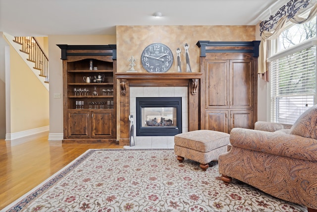 4902 Cochero Ct, Columbia, MO 65203 - living room featuring wood finished floors, stairway, and a fireplace