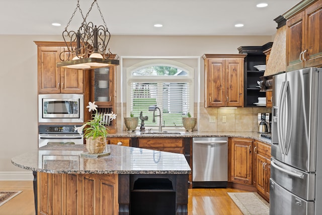 4902 Cochero Ct, Columbia, MO 65203 - kitchen with stainless steel appliances, open shelves, backsplash, recessed lighting, and light stone counters
