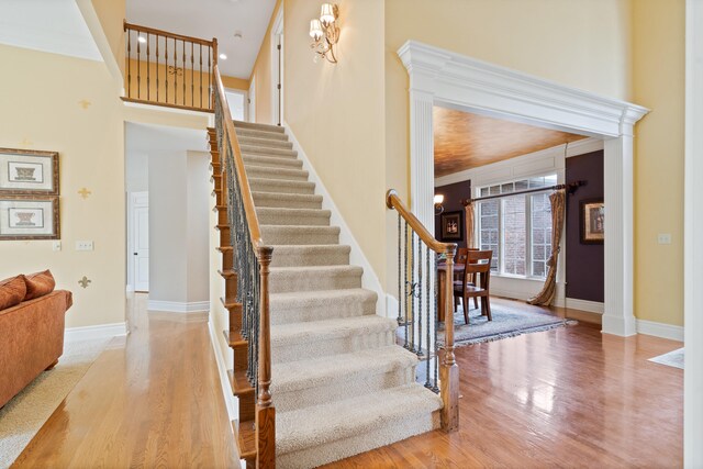 4902 Cochero Ct, Columbia, MO 65203 - staircase with wood finished floors and a towering ceiling