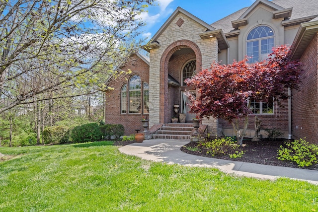 4902 Cochero Ct, Columbia, MO 65203 - view of front of property with a front yard, stucco siding, and brick siding