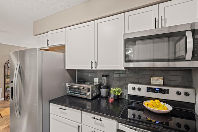 1612 Garden Dr Unit A & B, Columbia, MO 65202 - kitchen with stainless steel appliances, tasteful backsplash, white cabinetry, dark stone counters, and wood finished floors