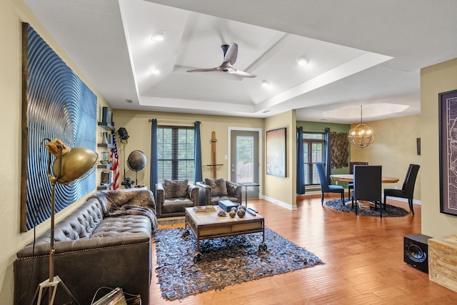 3509 Tuscany, Columbia, MO 65202 - living room with a raised ceiling, wood finished floors, ceiling fan, a chandelier, and plenty of natural light