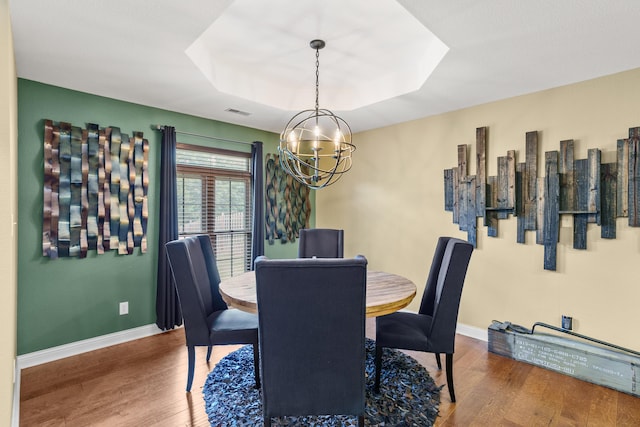 3509 Tuscany, Columbia, MO 65202 - dining space featuring a chandelier, wood finished floors, and a raised ceiling