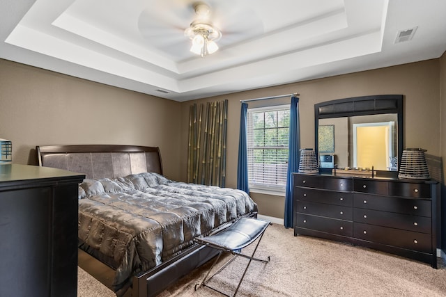 3509 Tuscany, Columbia, MO 65202 - bedroom featuring a raised ceiling, light colored carpet, and a ceiling fan