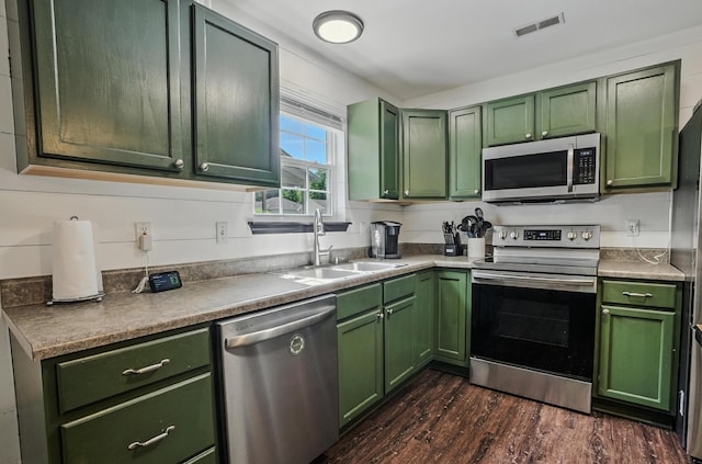 5 Amazon Dr, Columbia, MO 65202 - kitchen with green cabinets, appliances with stainless steel finishes, and dark wood-type flooring