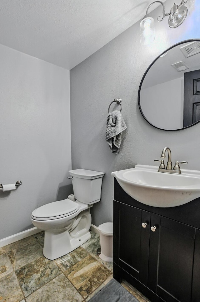 5 Amazon Dr, Columbia, MO 65202 - half bathroom with vanity, stone finish flooring, and a textured ceiling