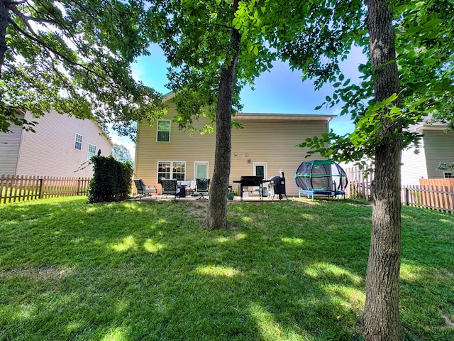5 Amazon Dr, Columbia, MO 65202 - back of house featuring a patio, a fenced backyard, and a trampoline