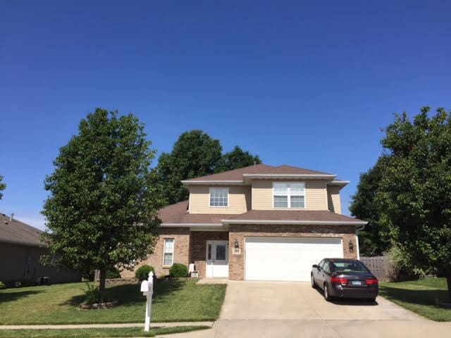 201 Port Way, Columbia, MO 65201 - traditional-style house with concrete driveway, a garage, a front yard, and brick siding