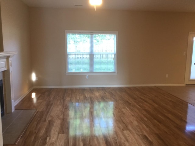 201 Port Way, Columbia, MO 65201 - unfurnished living room featuring wood finished floors and a fireplace with flush hearth