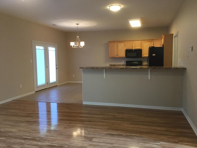 201 Port Way, Columbia, MO 65201 - kitchen with black appliances, light brown cabinets, dark countertops, a chandelier, and a peninsula