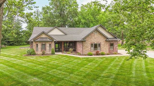 315 W Proctor St, Sturgeon, MO 65284 - view of front facade featuring stone siding, a front lawn, roof with shingles, and brick siding