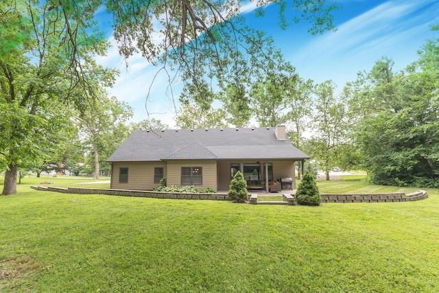 315 W Proctor St, Sturgeon, MO 65284 - rear view of house with a chimney, a yard, and a shingled roof